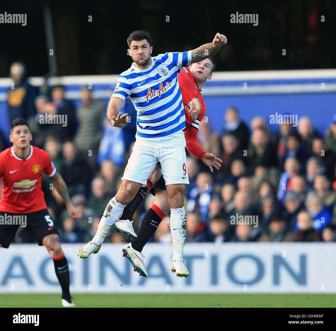 QPR's Charlie Austin tussles with Manchester United's Wayne Rooney during the Barclays Premier League match between Queens Park Rangers and Manchester United at Loftus Road, London on January 17, 2015. Stock Photo