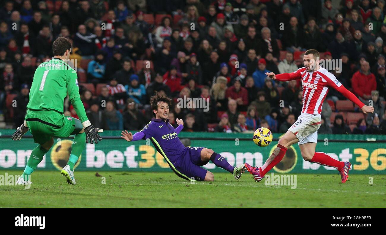 David Silva of Manchester City crosses the ball for Sergio Aguero of Manchester City to score only for it to be disallowed during the Barclays Premier League match between Stoke City and Manchester City at Britannia Stadium, London, United Kingdom on February 11, 2015. Stock Photo