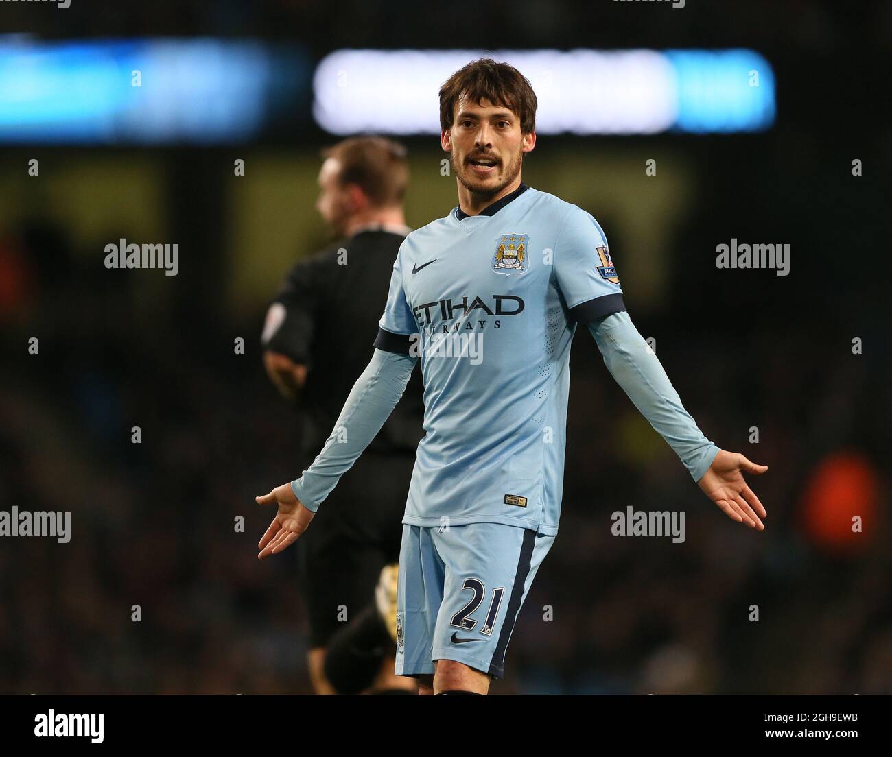 David Silva of Manchester City holds out his arms defence as Sergio Aguero of Manchester City questions his pass during the Barclays Premier League match between Manchester City and Leicester City at the Etihad Stadium, Manchester, England on 4th March 2015. Picture Simon Bellis. Stock Photo