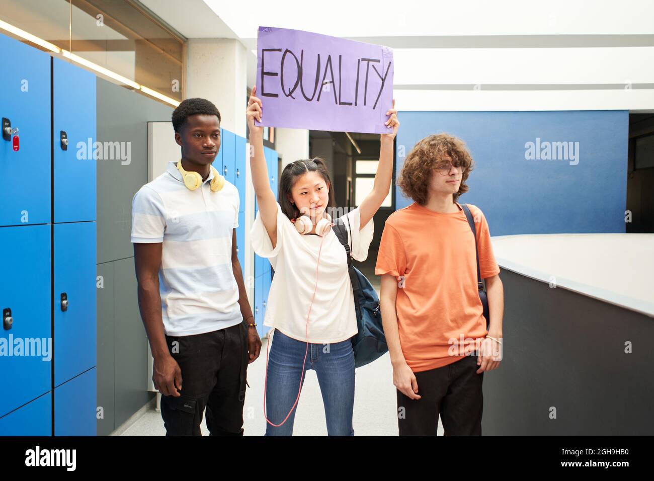 Group of students carrying a banner at school protesting for equality