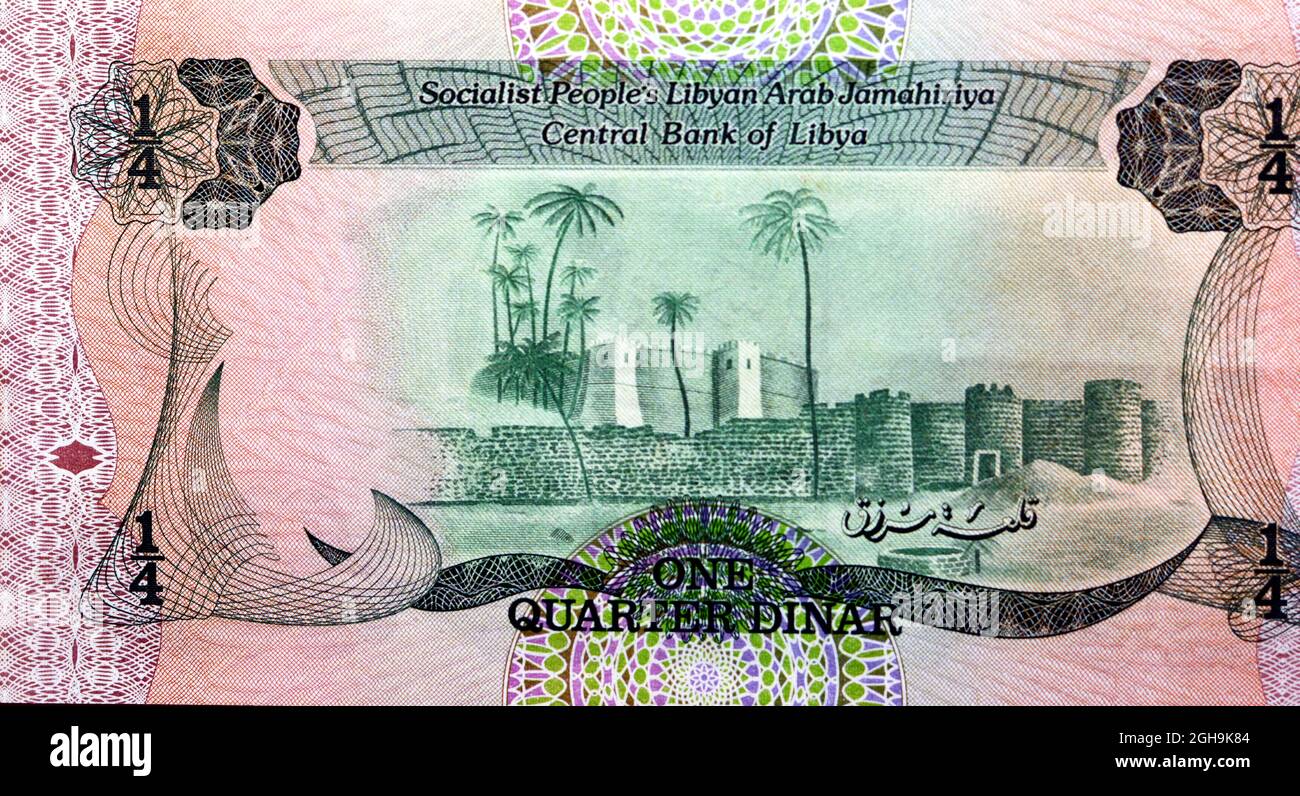 Large fragment of the reverse side of one quarter Libyan dinar banknote currency issued 1984 by the central bank of Libya with Marzuq fortress castle, Stock Photo