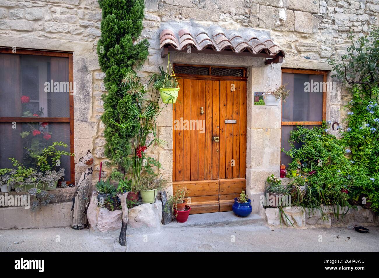 Wooden door in a street with flower pots and decorations Stock Photo
