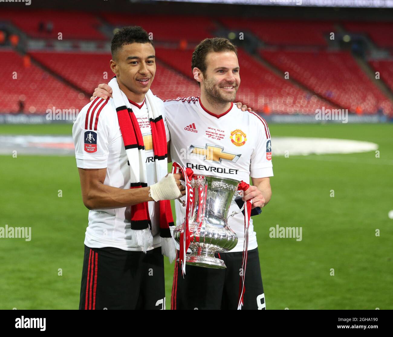 Manchester United's Jesse Lingard and Juan Mata celebrate with the trophy  during the Emirates FA Cup