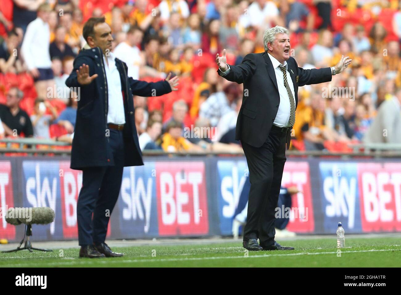 Sheffield Wednesdayâ€™s manager, Carlos Carvalhal and Hullâ€™s manager, Steve Bruce react during the Skybet Championship Play Off Final match at Wembley Stadium. Photo credit should read: Philip Oldham/Sportimage via PA Images Stock Photo