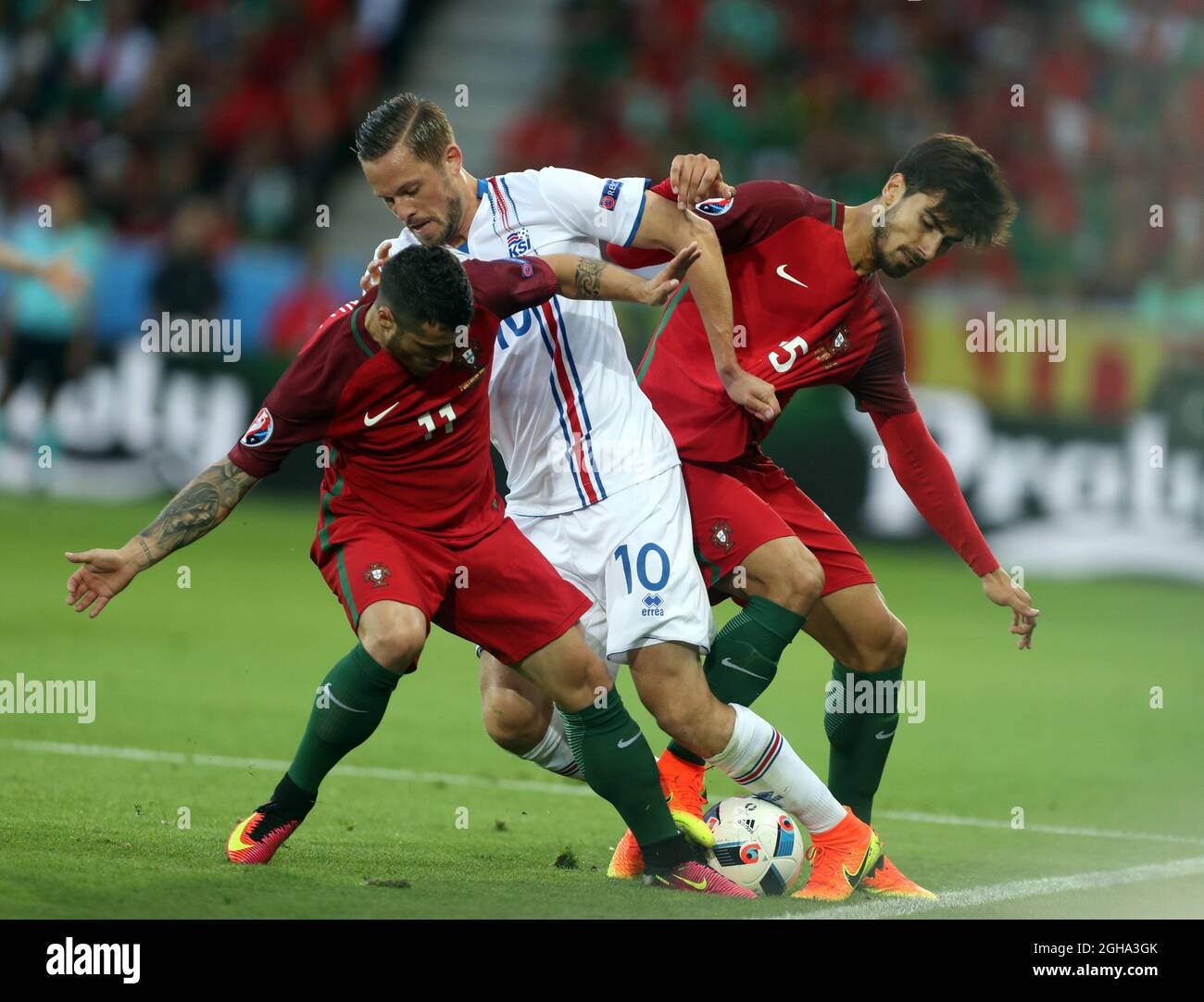 Gylfi Sigurdsson of Iceland tackled by Vieirinha and  Raphael Guerreiro of Portugal during the UEFA European Championship 2016 match at the Stade Geoffroy Guichard, Saint Etienne. Picture date June 15th, 2016 Pic Phil Oldham/Sportimage via PA Images Stock Photo