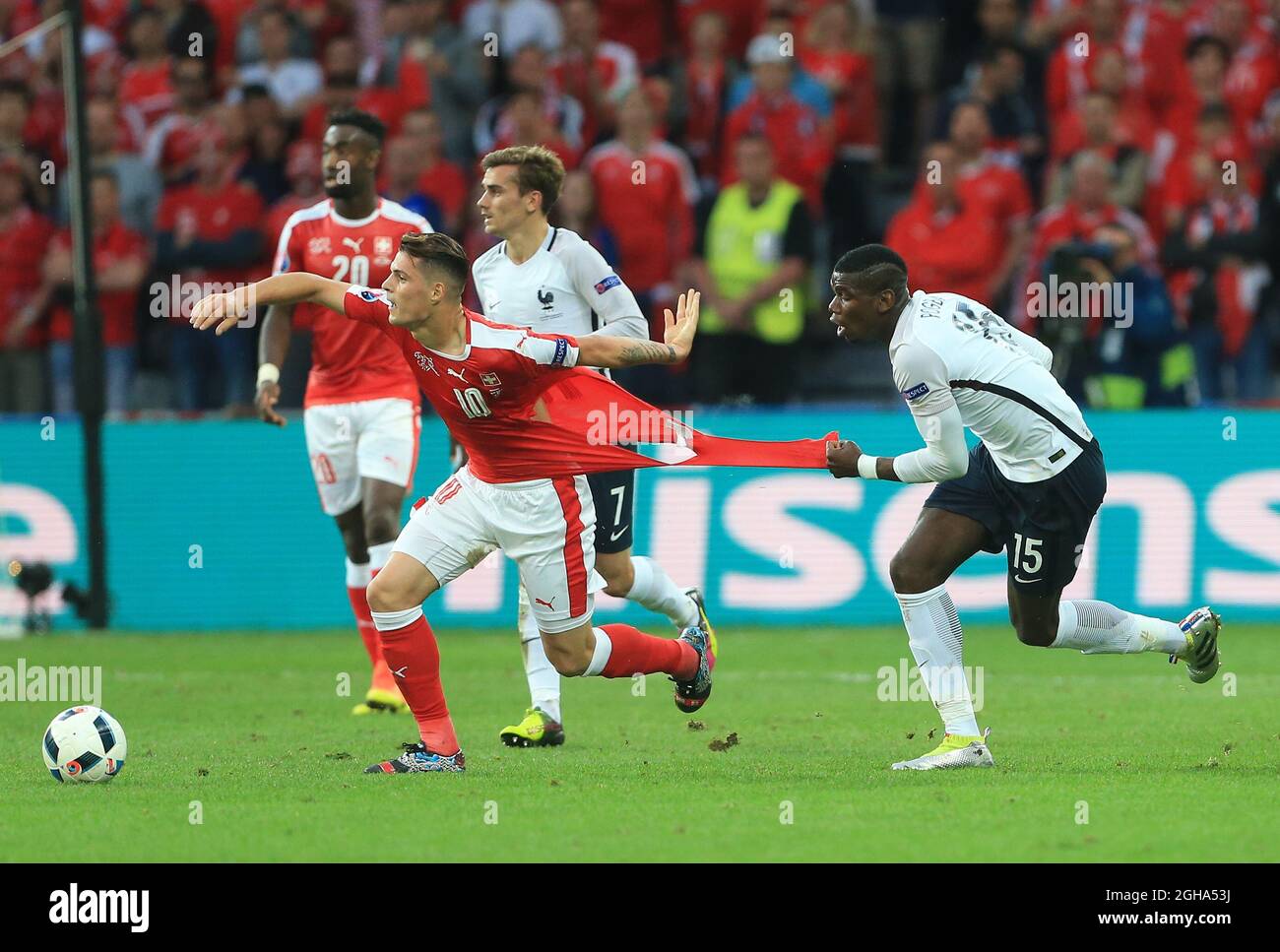 switzerlands-granit-xhaka-gets-his-shirt-pulled-by-frances-paul-pogba-during-the-uefa-european-championship-2016-match-at-the-stade-pierre-mauroy-lille-picture-date-june-19th-2016-pic-david-kleinsportimage-via-pa-images-2GHA53J.jpg