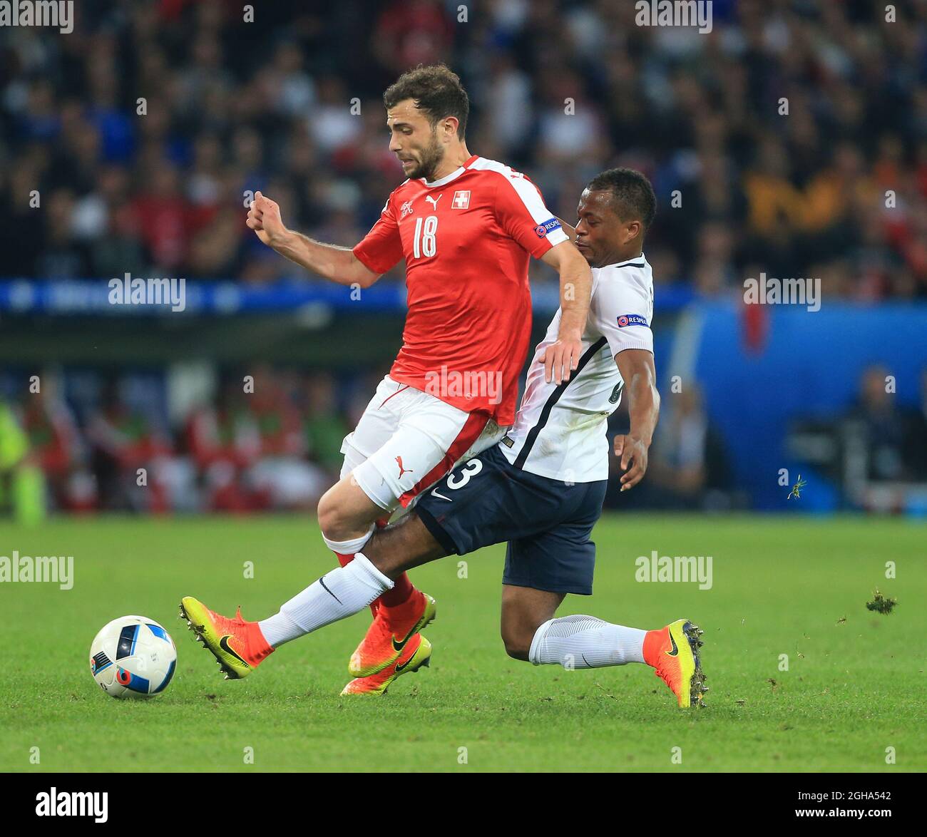 Switzerland's Admir Mehmedi tussles with France's Patrice Evra during the UEFA European Championship 2016 match at the Stade Pierre-Mauroy, Lille. Picture date June 19th, 2016 Pic David Klein/Sportimage via PA Images Stock Photo