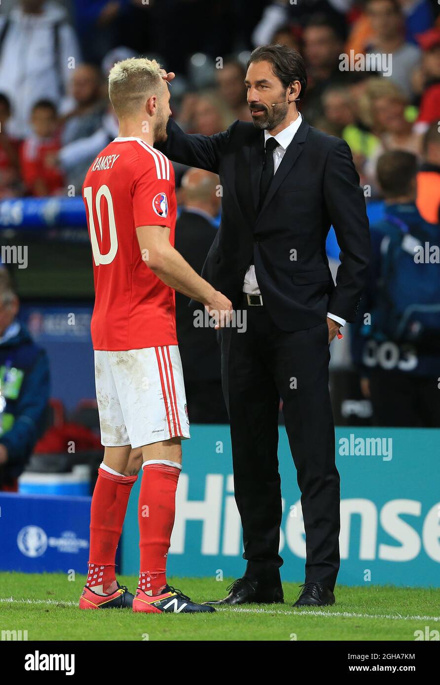 Aaron Ramsey of Wales talks to former Arsenal Robert Pires during the UEFA European Championship 2016 match at the Stadium Pierre Mauroy, Lille. Picture date July 01, 2016 Pic David Klein/Sportimage via PA Images Stock Photo