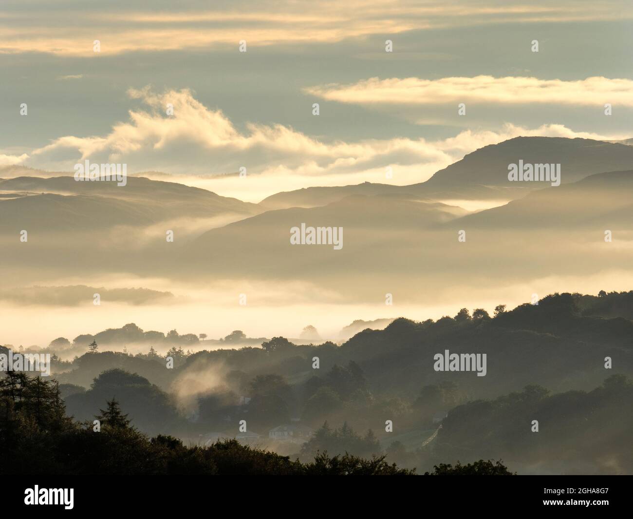 Early morning mist over the lower Duddon Valley at sunrise, Cumbria, UK. Stock Photo