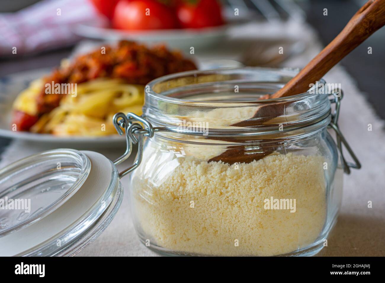 Jar with grated parmesan cheese Stock Photo
