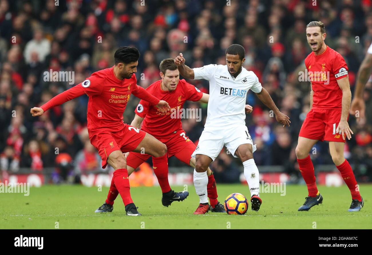 Wayne Routledge of Swansea City  is surrounded by Emre Can, James Milner and Jordan Henderson of Liverpool during the Premier League match at Anfield, Liverpool. Picture date: January 21st, 2017 .Photo credit should read: Lynne Cameron/Sportimage  via PA Images Stock Photo