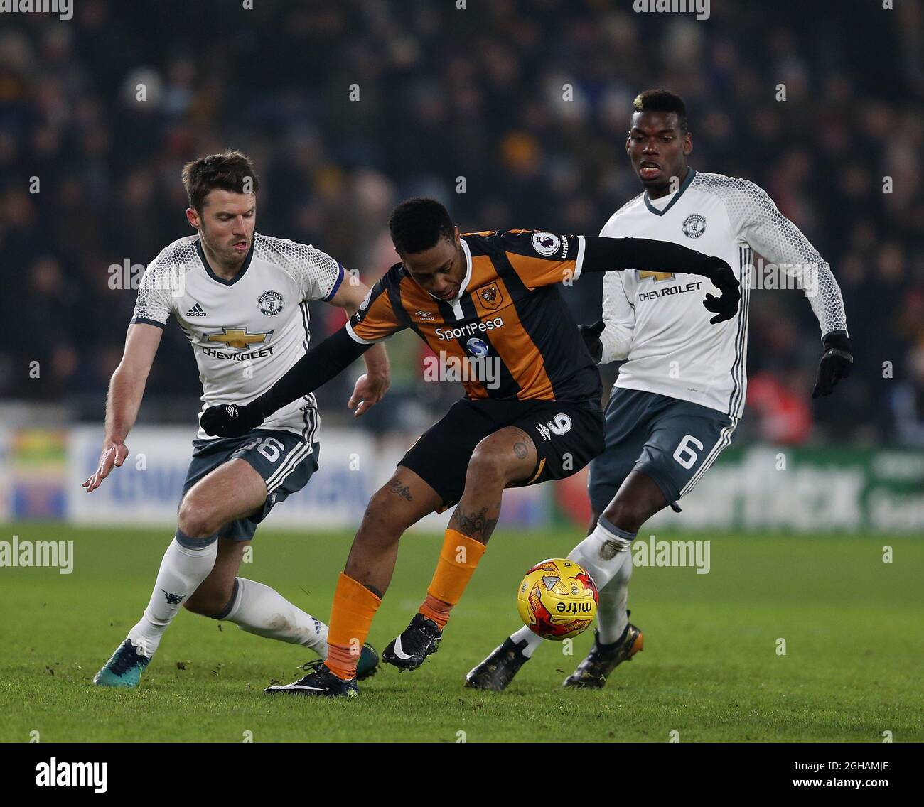 Michael Carrick and Paul Pogba of Manchester United in action with Abel Hernandez of Hull City during the EFL Semi-Final 2nd Leg match at KCOM Stadium, Hull. Picture date: January 26th, 2017. Pic credit should read: Simon Bellis/Sportimage via PA Images Stock Photo