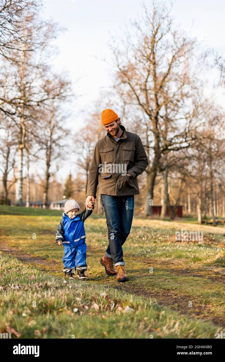 Father and his son walking together holding hands hi-res stock ...