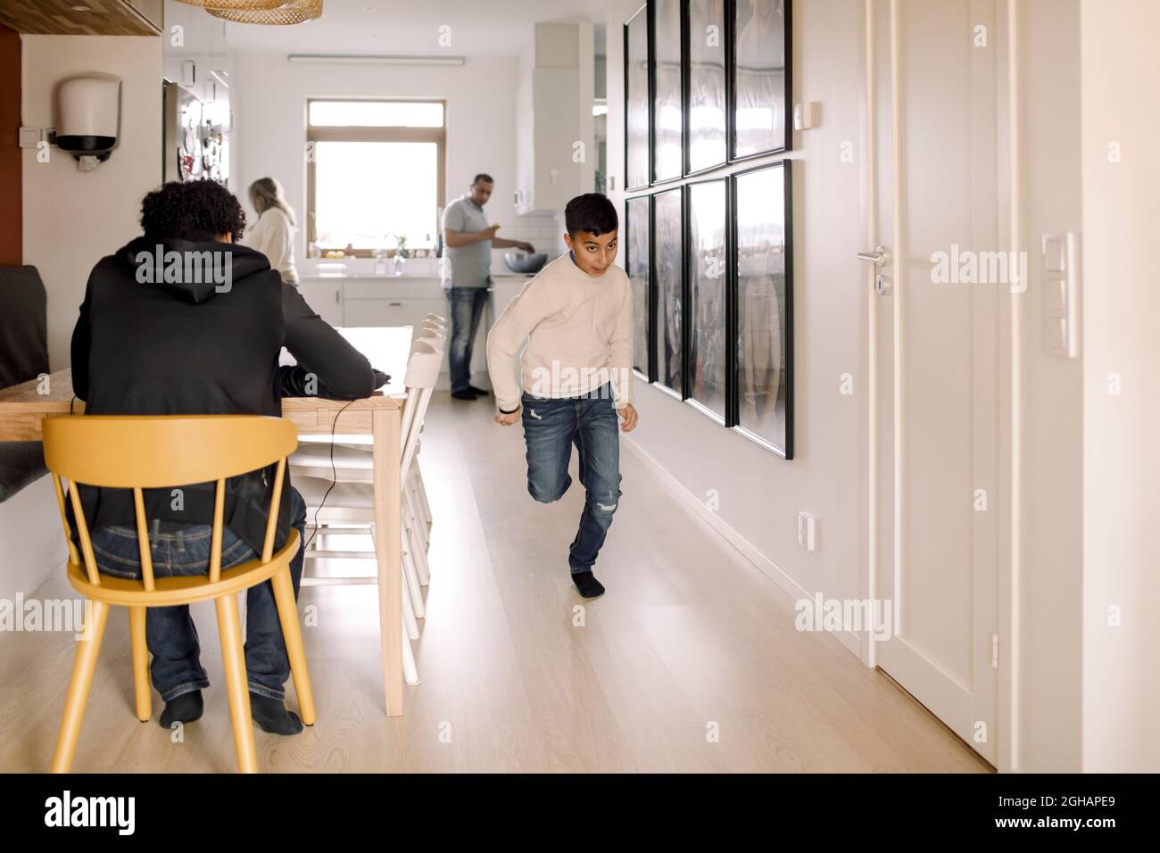 Autistic boy running in living room Stock Photo Alamy