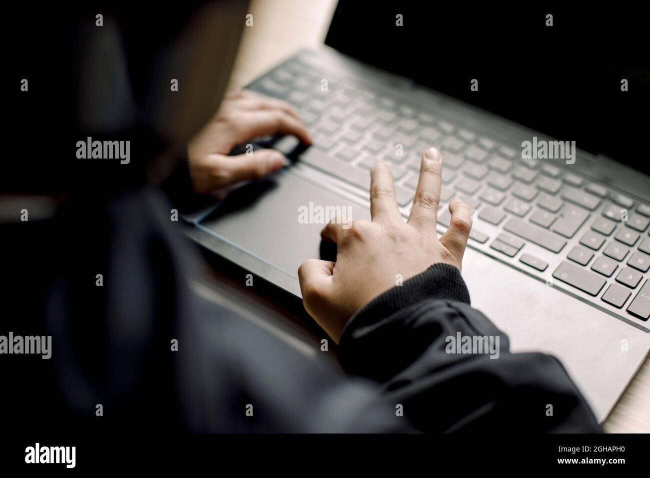 Midsection of boy playing game on laptop at home Stock Photo