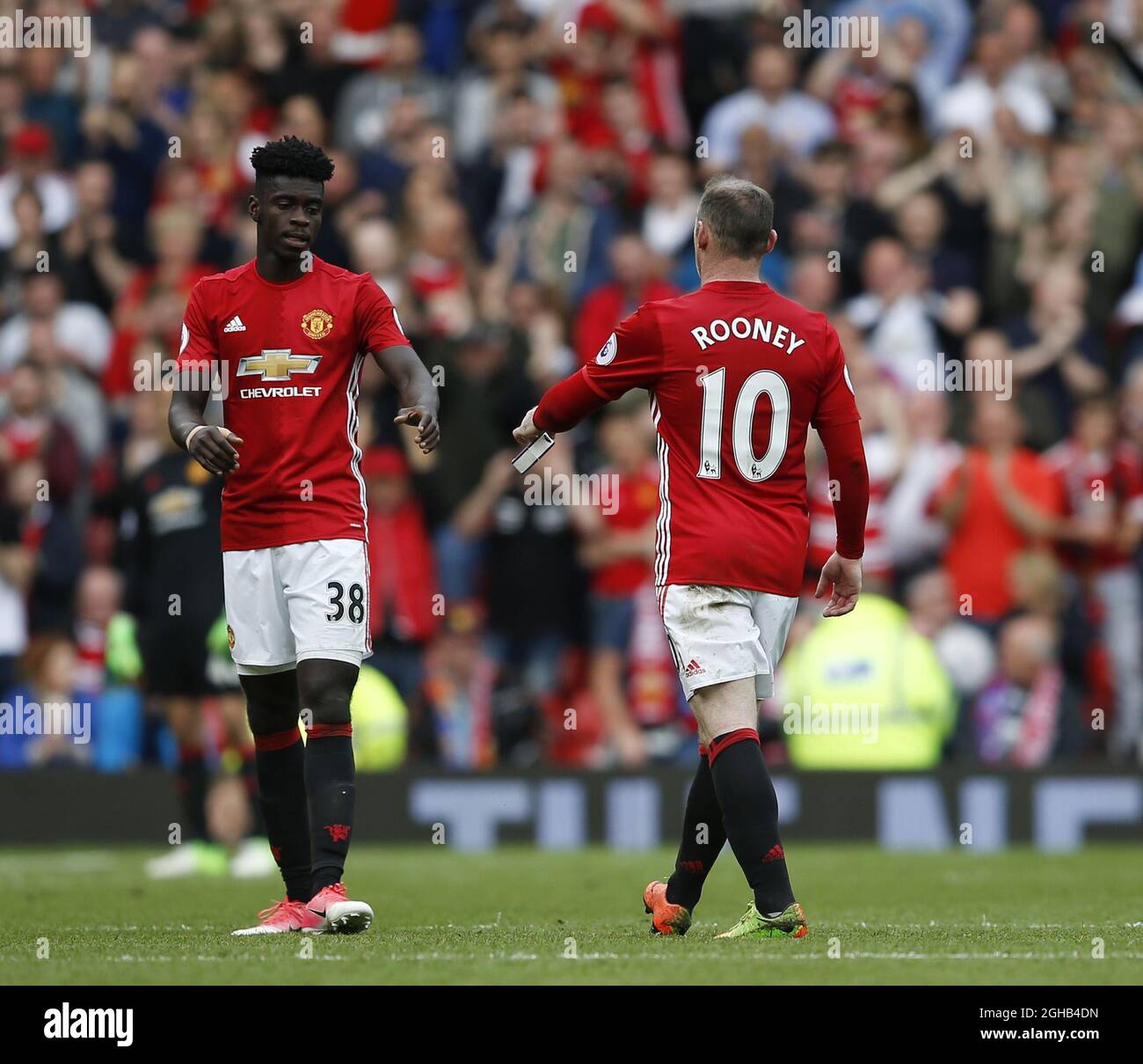 Wayne Rooney of Manchester United hands over the captains armband to