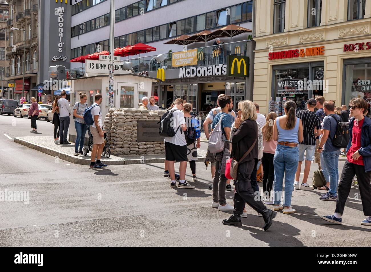 Berlin, Germany - August 4, 2021: Group of people at the Checkpoint Charlie, old Berlin Wall crossing point between East and West Berlin, city landmar Stock Photo