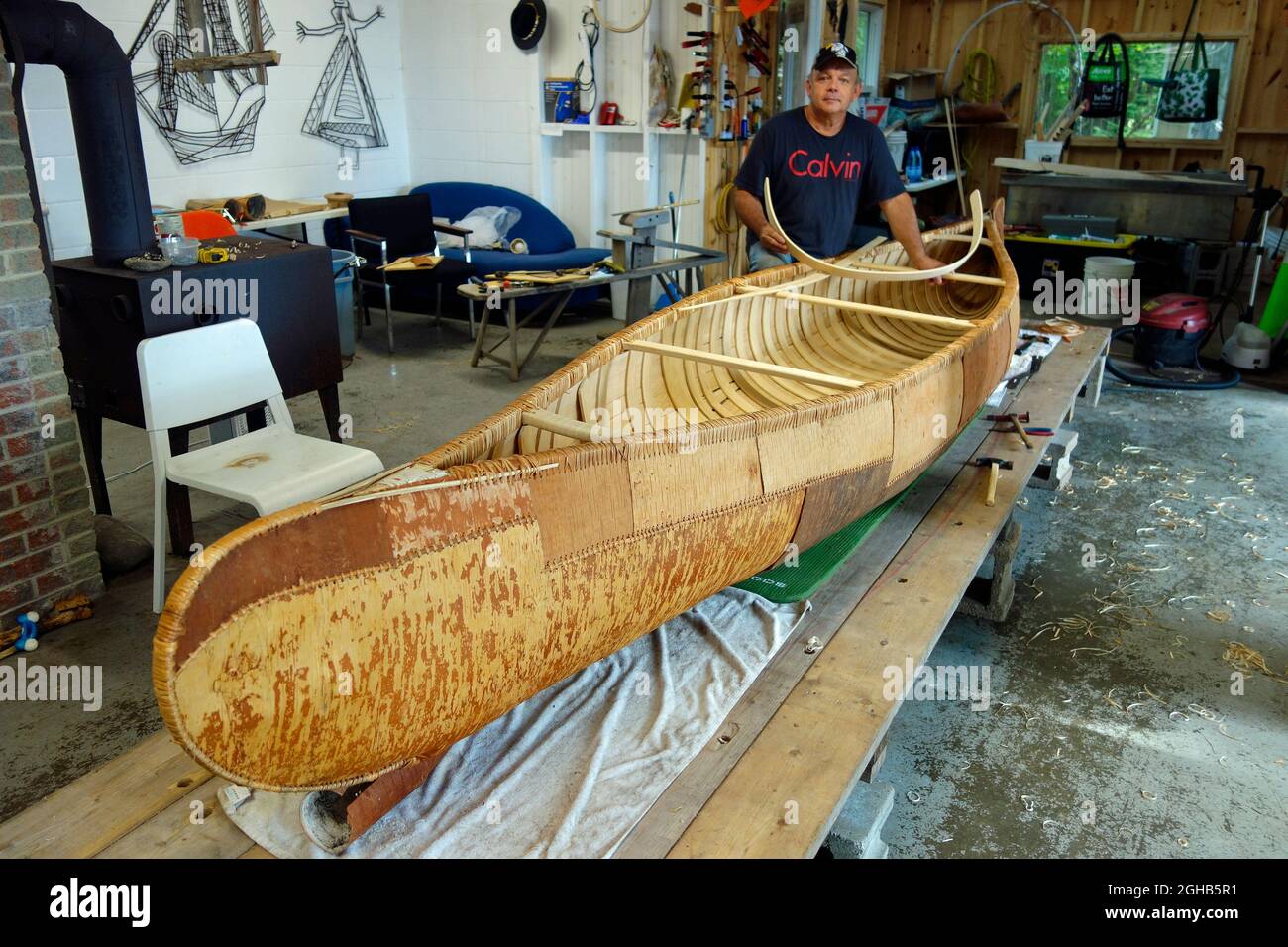 Canoe builder Todd Labrador at Birch bark canoe workshop at Kejimkujik National Park, Nova Scotia, Canada Stock Photo