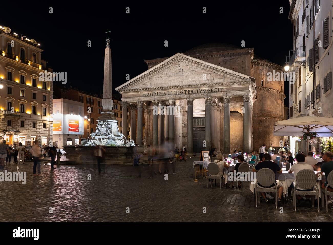 Rome, Italy - September 6, 2020: Pantheon at night, ancient Roman temple at Piazza della Rotonda square with people at restaurant tables, fountain and Stock Photo