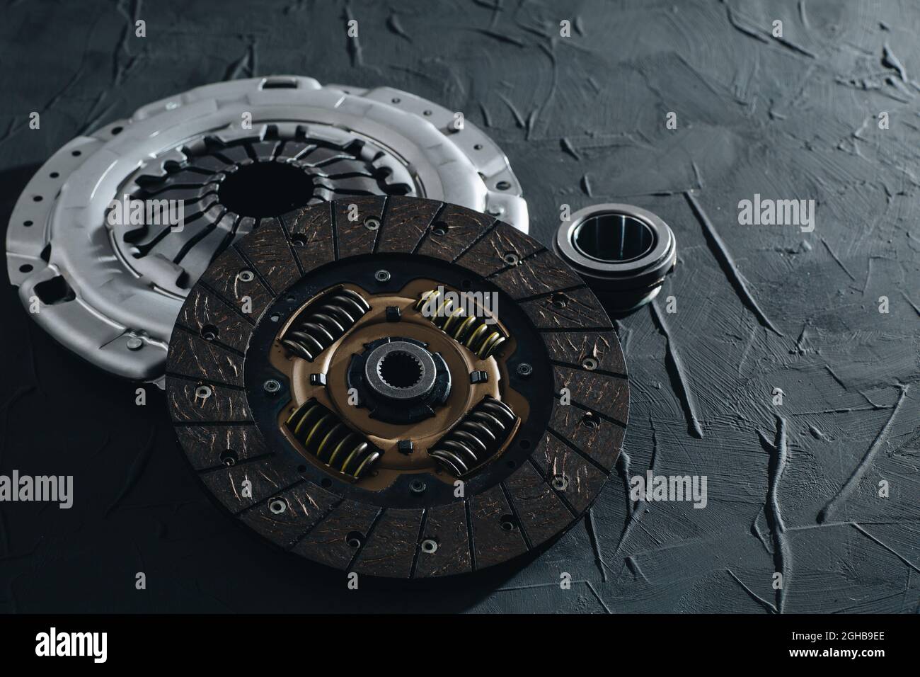 Automotive clutch mechanism, disc, basket and bearing for auto on a black background. Car parts. Close up Stock Photo