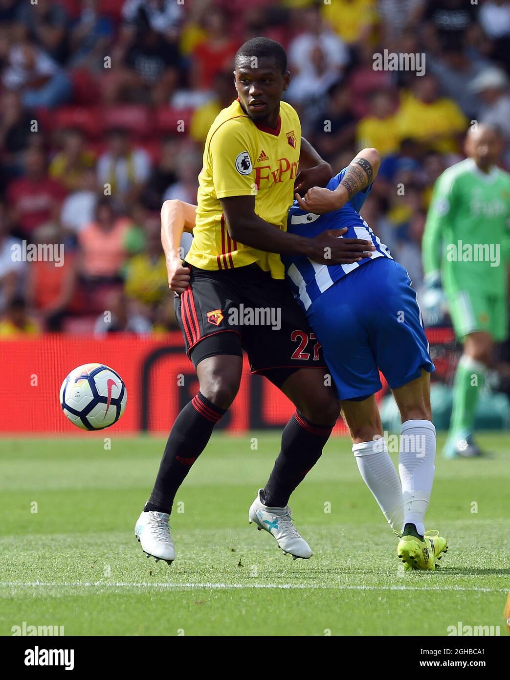 Christian Kabasele of Watford is challenged Pascal Grob of Brighton & Hove  Albion by during the premier league match at the Vicarage Road Stadium,  Watford. Picture date 26th August 2017. Picture credit