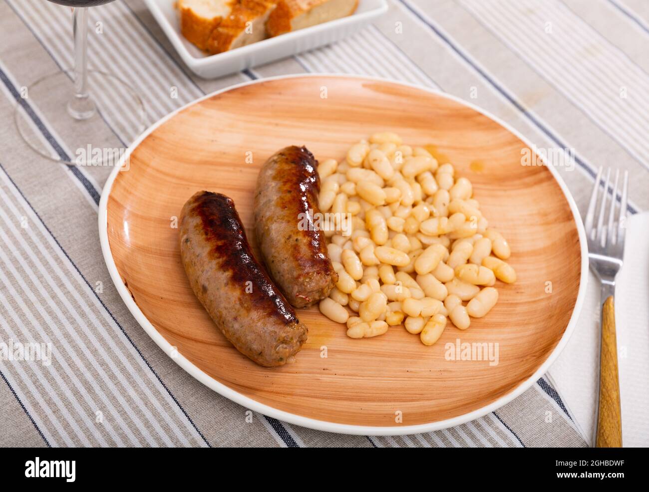 Traditional Catalan dish of fried pork sausage Butifarra with a side ...