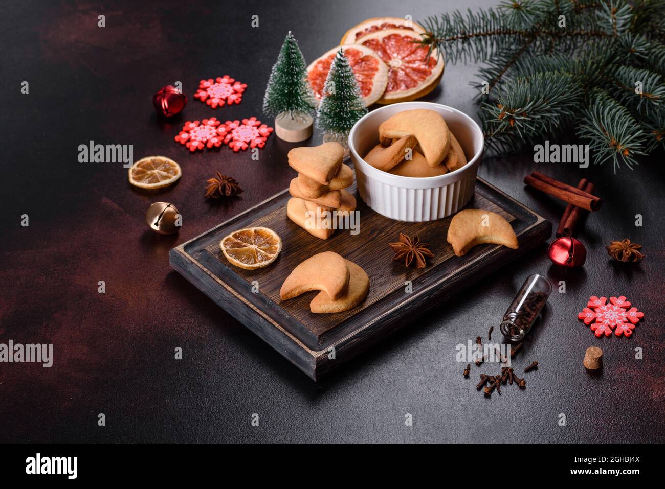 Christmas frame with fir tree branches, gingerbread cookies, spices ...