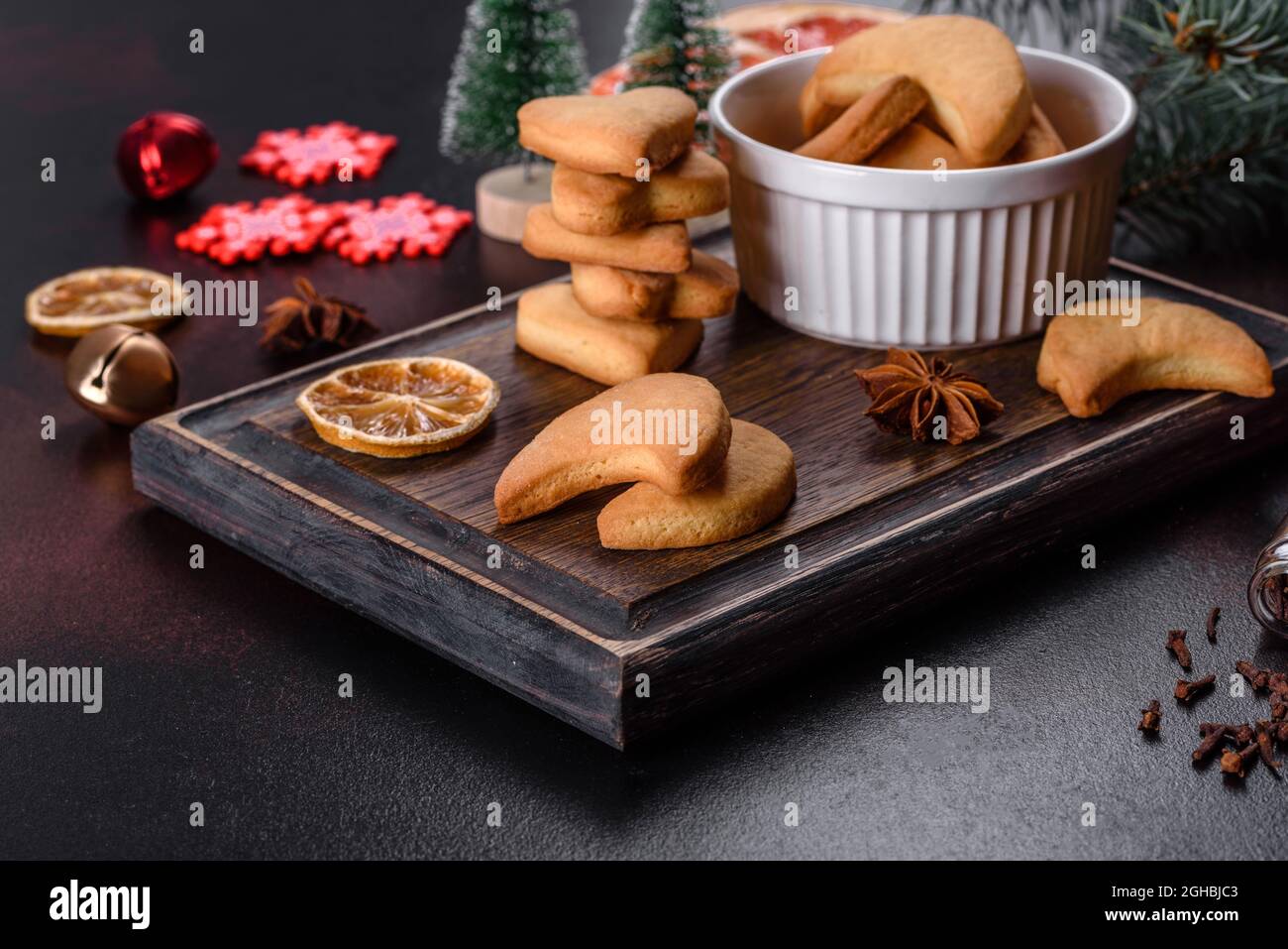 Christmas frame with fir tree branches, gingerbread cookies, spices ...