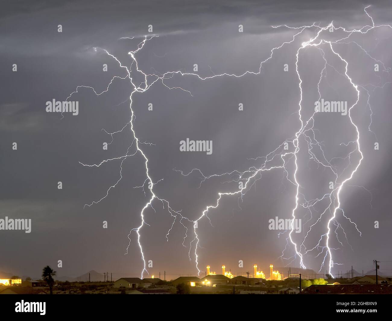 Lightning striking near a power plant in Arlington AZ during the 2016 monsoon season. Stock Photo