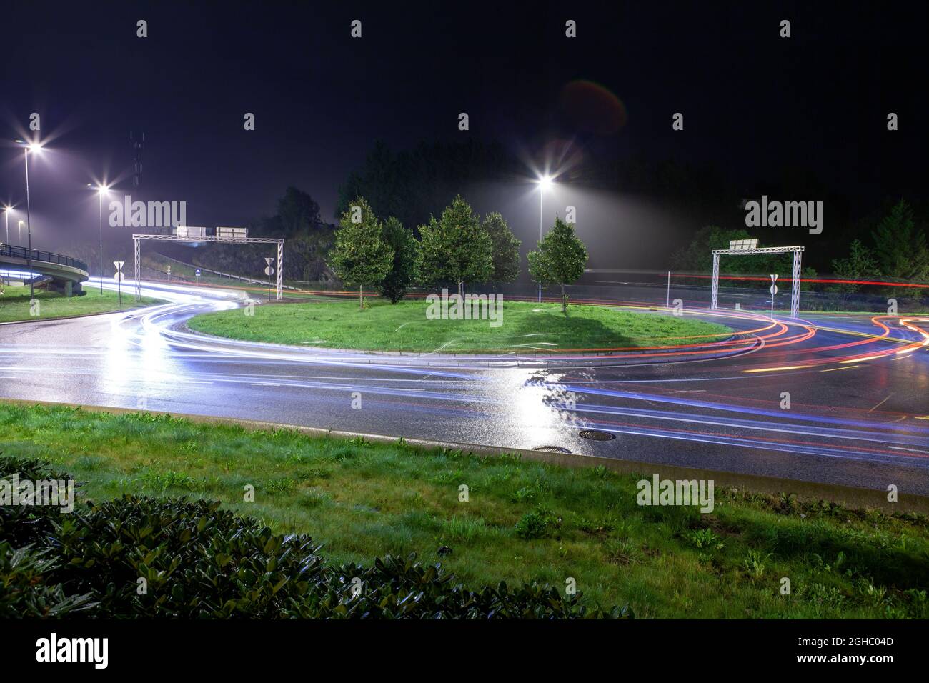 Roundabout in Bergen Norway at night. Light trail from cars. Stock Photo
