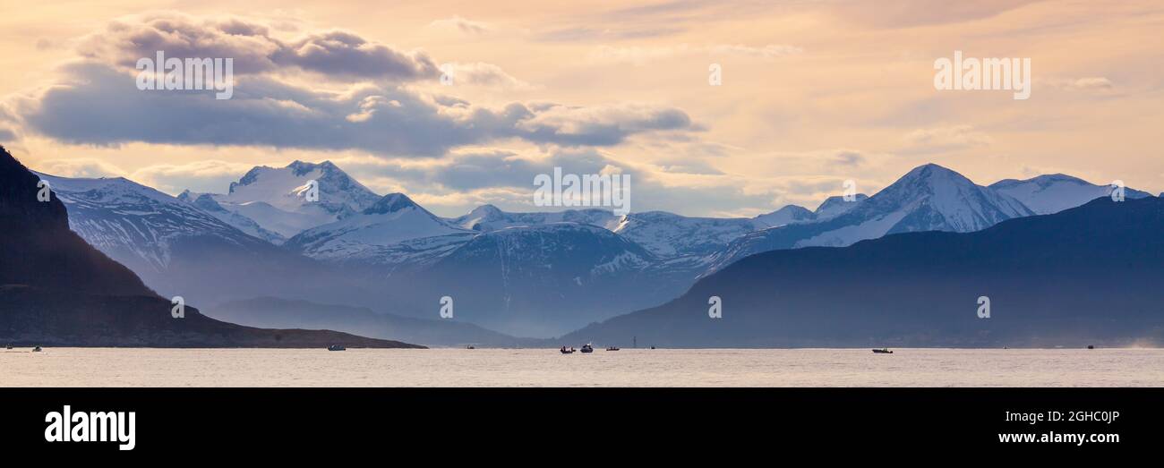 Beautiful seascape of Norway. Colorful sky and mountains in background. Stock Photo