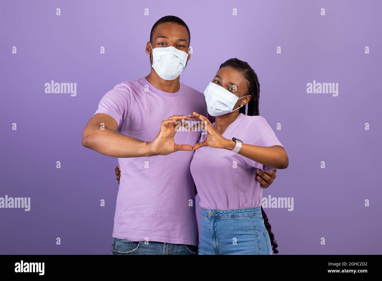 African American couple in mask making heart gesture Stock Photo