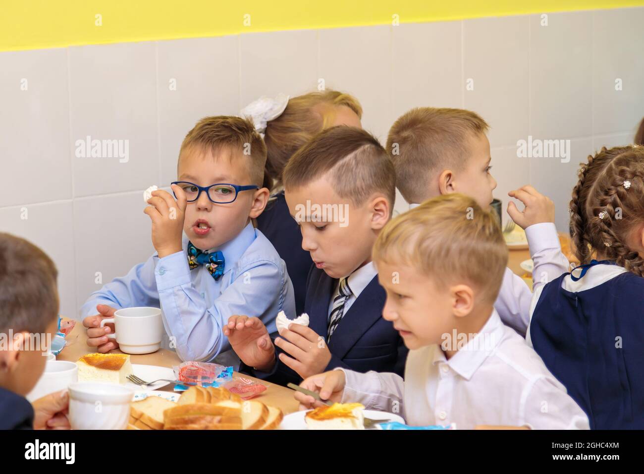 First graders eat in the school cafeteria. School lunch in the cafeteria on September 1st. Moscow, Russia, September 1, 2021 Stock Photo