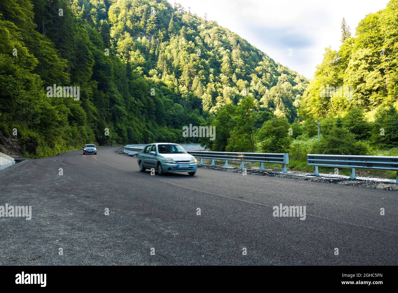 Rental car moving fast on the autobahn with beautiful nature autumn