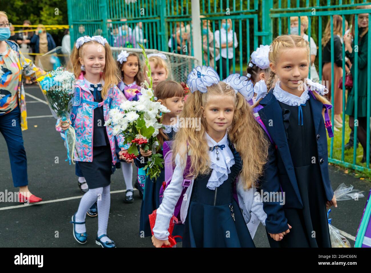 First graders walk with bouquets on September 1. Children go to school, first grade with flowers. School education concept. Moscow, Russia, September Stock Photo