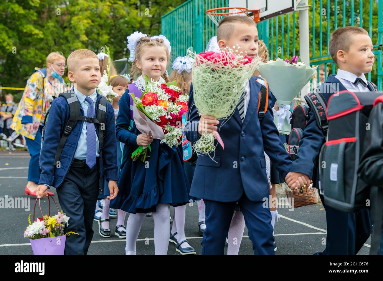 First graders walk with bouquets on September 1. Children go to school, first grade with flowers. School education concept. Moscow, Russia, September Stock Photo