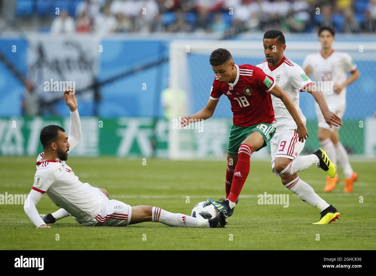Roozbeh Cheshmi of IR Iran tackles Amine Harit of Morocco during the FIFA World Cup 2018 Group B match at the St Petersburg Stadium, St Petersburg. Picture date 15th June 2018. Picture credit should read: David Klein/Sportimage via PA Images Stock Photo