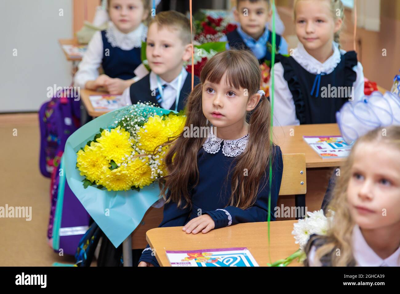 On September 1, children sit at their desks in class. First graders