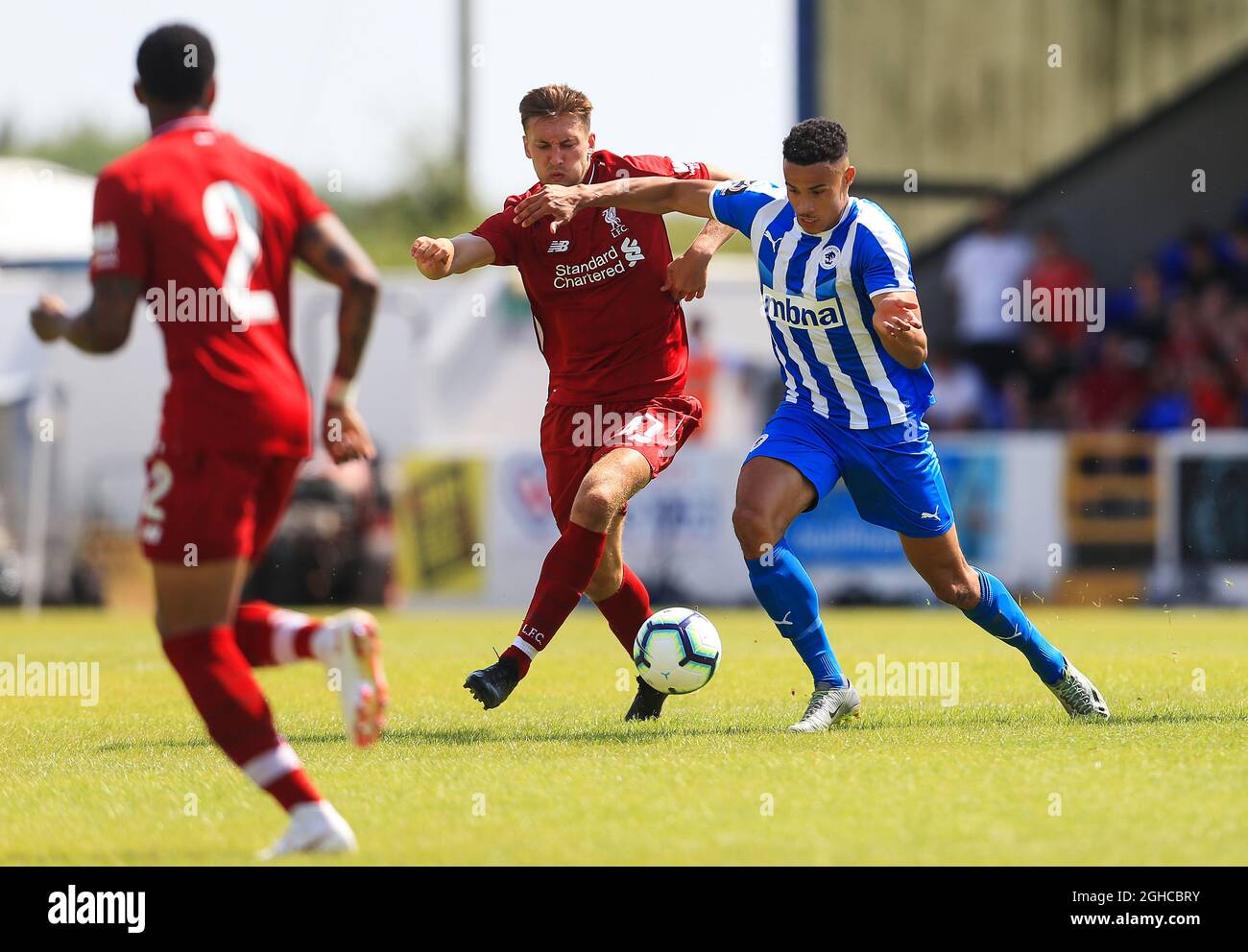Nathianiel Phillips of Liverpool battles with Jordan Archer of Chester FC  during the pre season match at the Swansway Chester Stadium, Chester.  Picture date 7th July 2018. Picture credit should read: Matt