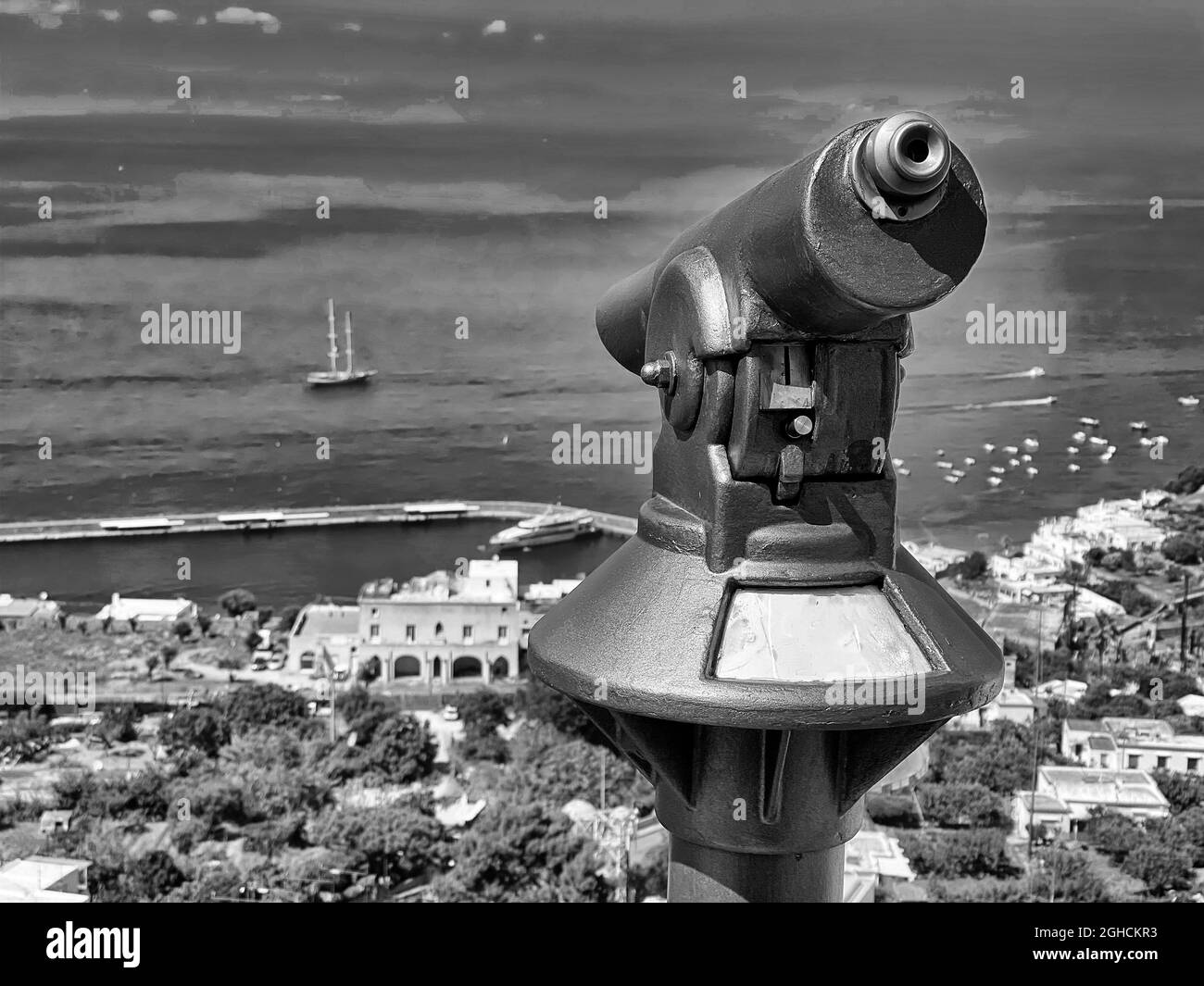 Grayscale shot of binoculars on the shore of the Tyrrhenian in Capri, Italy Stock Photo