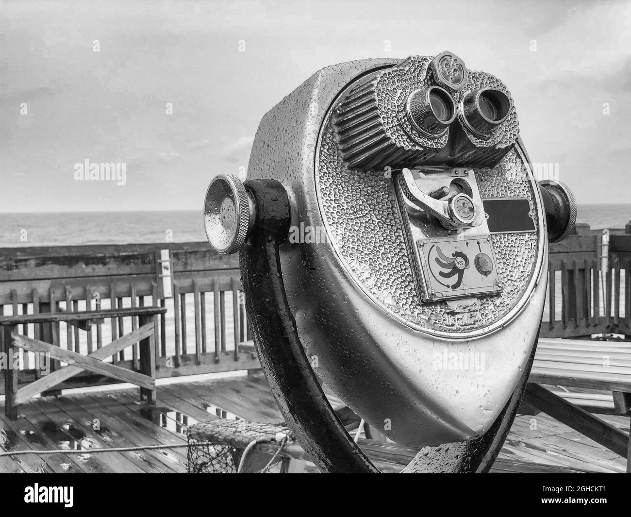Grayscale shot of binoculars on the shore of the Tyrrhenian in Capri, Italy Stock Photo