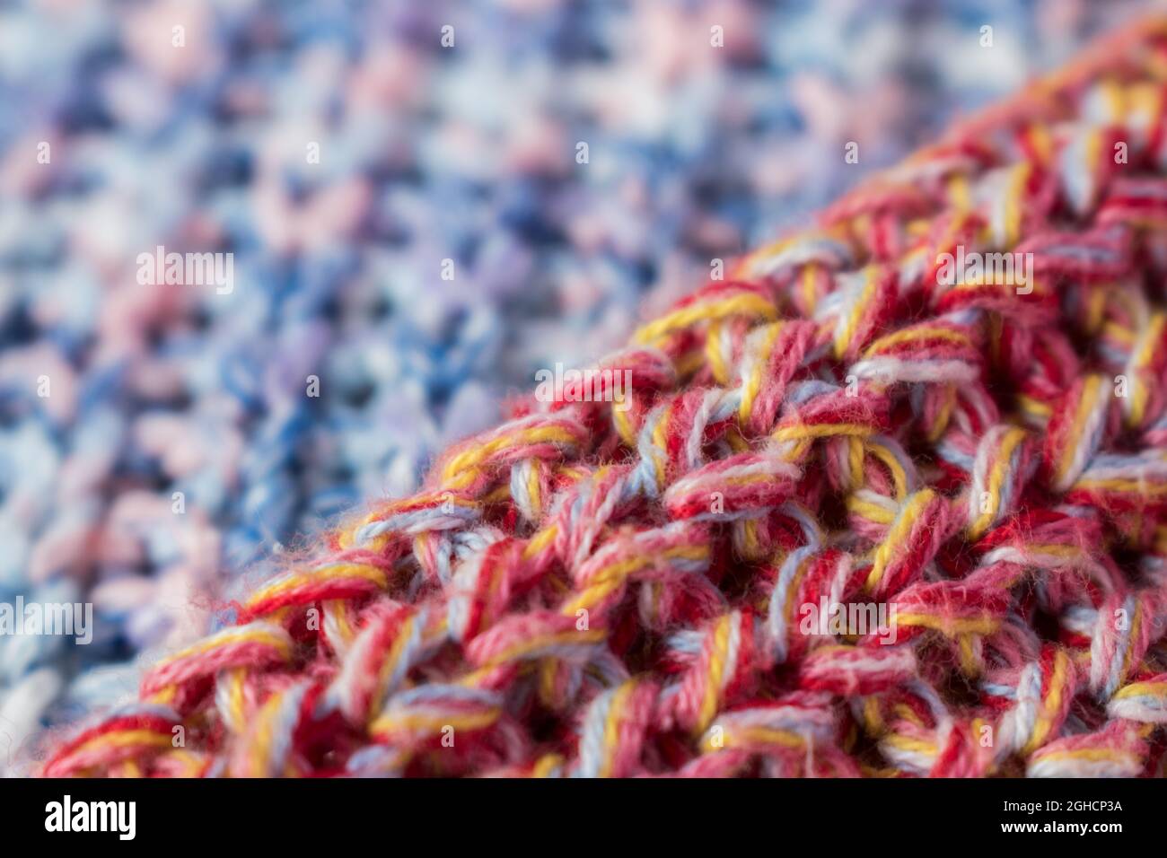 Close up of pink and yellow knitted wool texture of a sweater Stock Photo