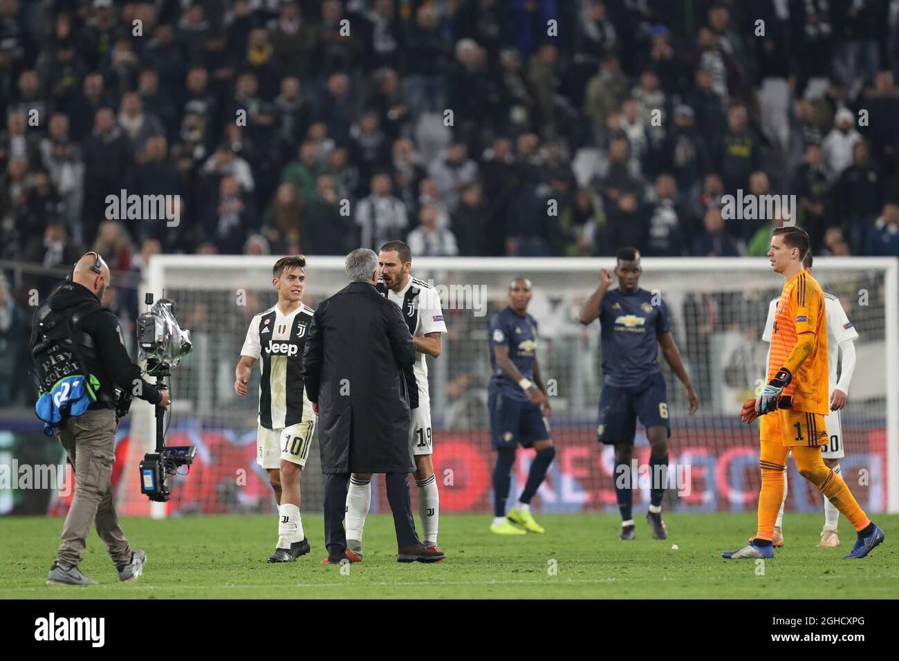 Jose Mourinho manager of Manchester United discusses with Leonardo Bonucci of Juventus after he held his hand to his ear to taunt the Juventus fans after the final whistle of the UEFA Champions League Group H  match at the Juventus Stadium, Turin. Picture date: 7th November 2018. Picture credit should read: Jonathan Moscrop/Sportimage  via PA Images Stock Photo