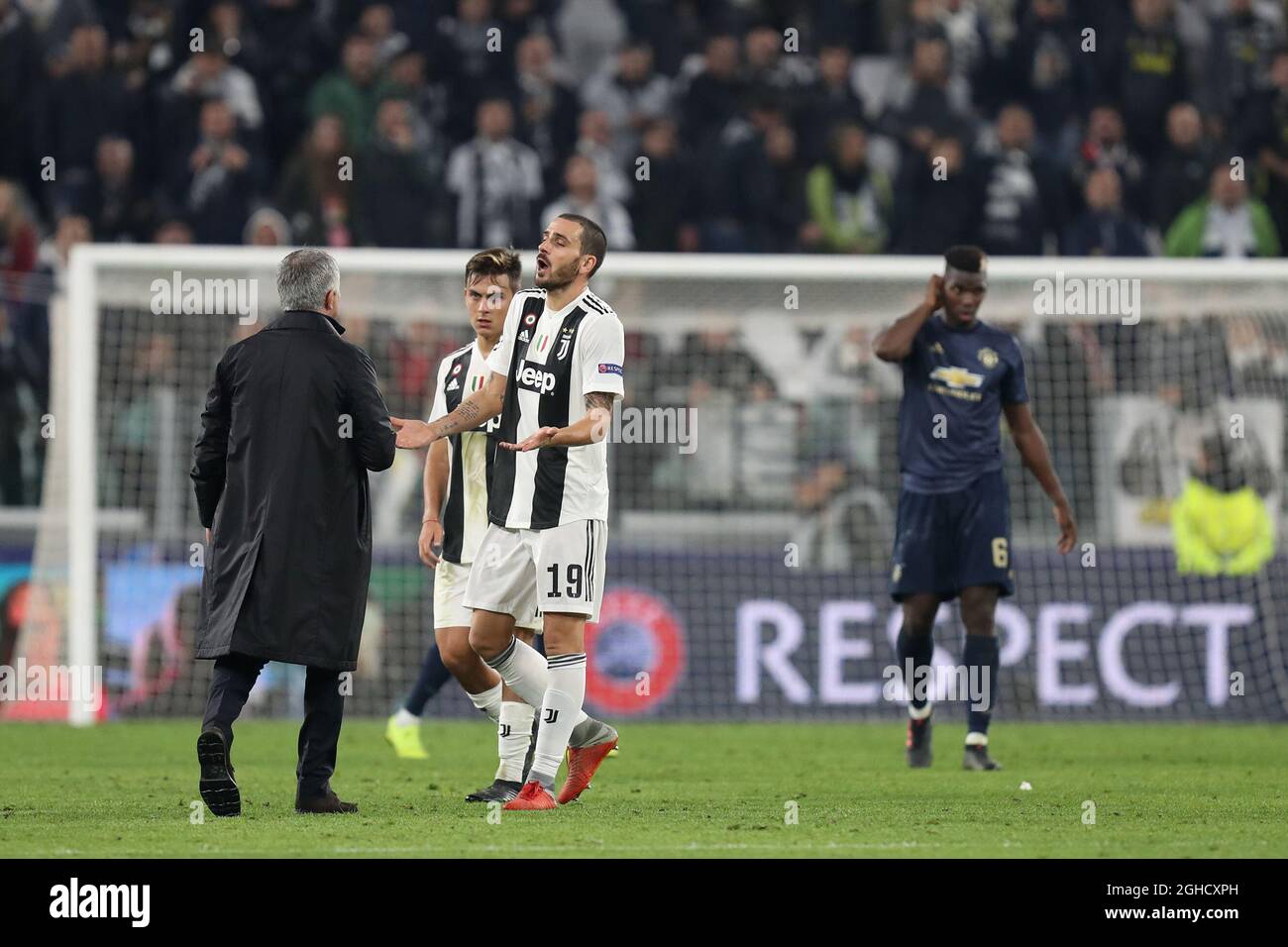 Jose Mourinho manager of Manchester United discusses with Leonardo Bonucci of Juventus after he held his hand to his ear to taunt the Juventus fans after the final whistle of the UEFA Champions League Group H  match at the Juventus Stadium, Turin. Picture date: 7th November 2018. Picture credit should read: Jonathan Moscrop/Sportimage  via PA Images Stock Photo