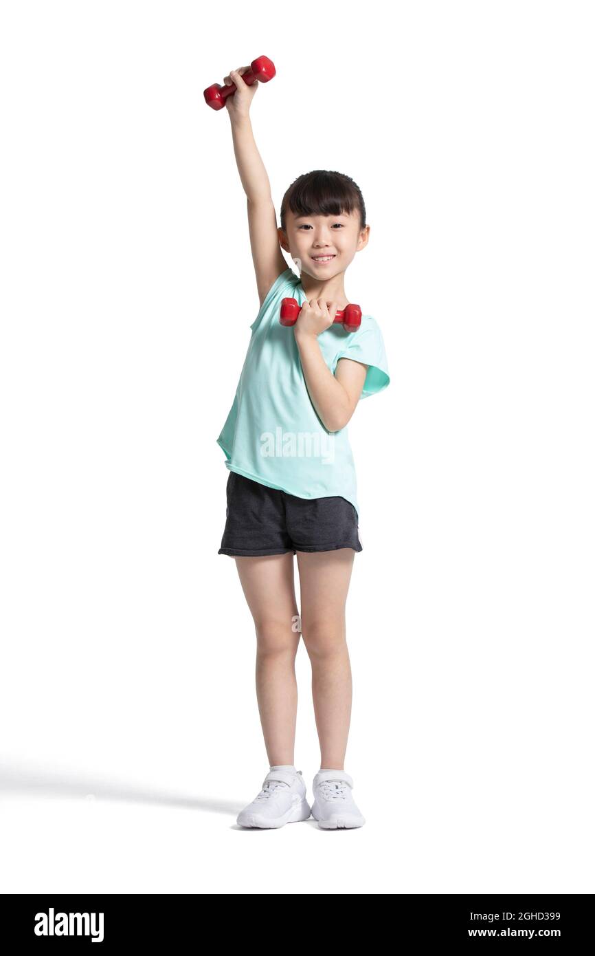 Happy little girl exercising with dumbbells Stock Photo - Alamy