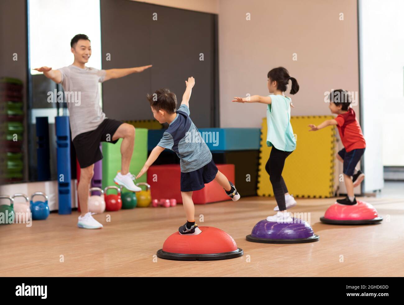 Cute children having exercise class in gym Stock Photo - Alamy
