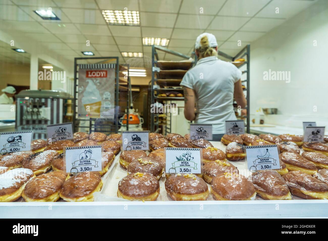 Krakow, Poland - August 28, 2018: Vendor with an assortment of traditional Paczki in a pastry shop in the historical center of Krakow, Poland Stock Photo