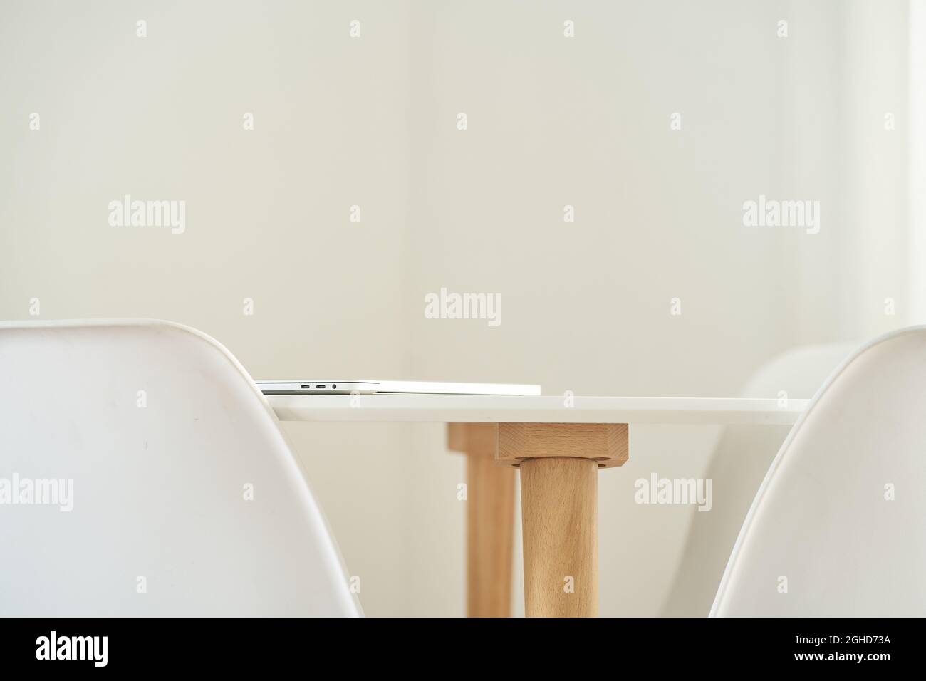 Close-up of a stylish white table with chairs. The concept of modern home decor.Copy space. High quality photo Stock Photo