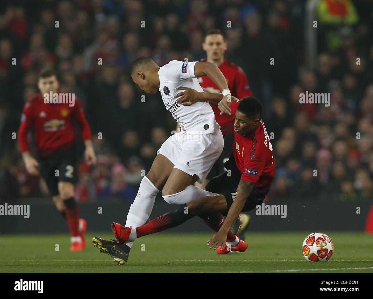 Marcus Rashford Of Manchester United Tackles Kylian Mbappe Of Ps During The Uefa Champions League Round Of 16 First Leg Match At The Old Trafford Stadium Manchester Picture Date 12th February 19