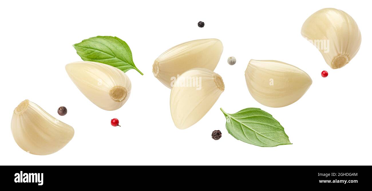 Falling peeled garlic cloves isolated on white background Stock Photo ...